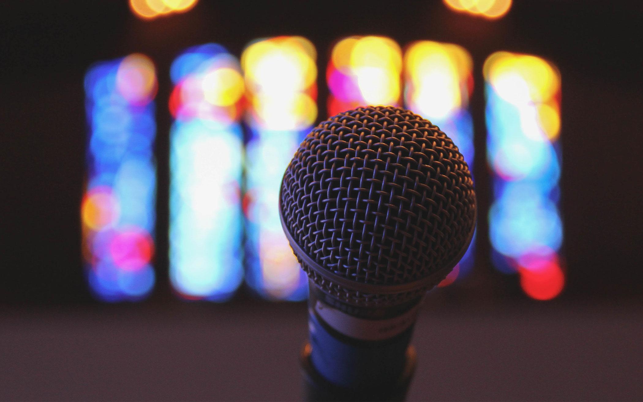 Microphone with stained glass in background.